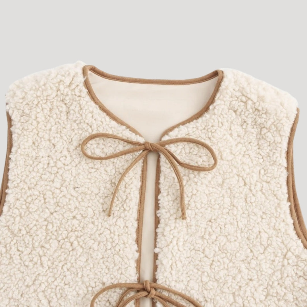 Beige tie-front vest close-up of tie detail