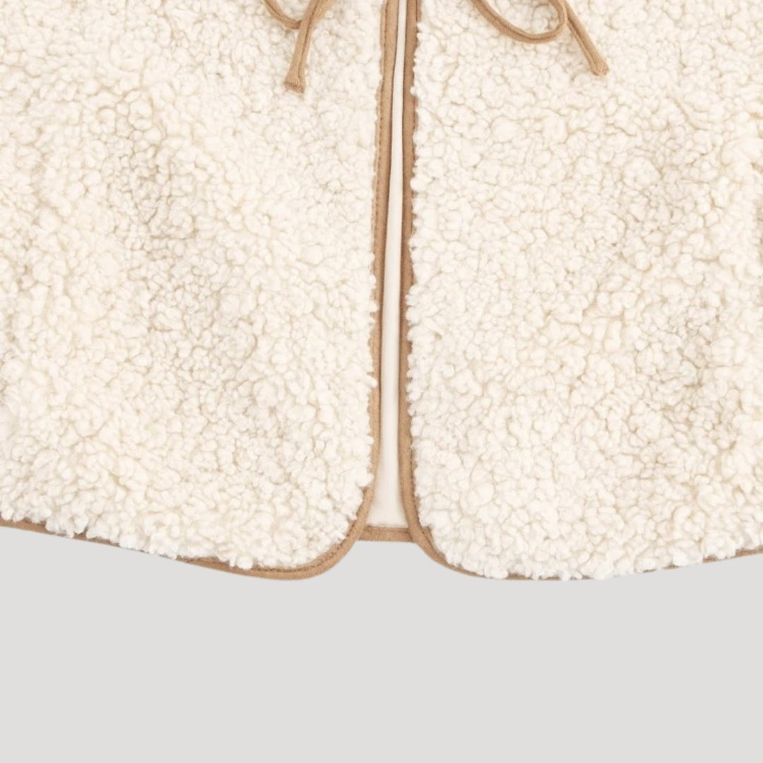 Model wearing beige tie-front vest with dress