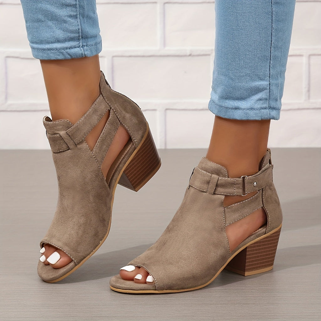Side view of buckle strap ankle boots