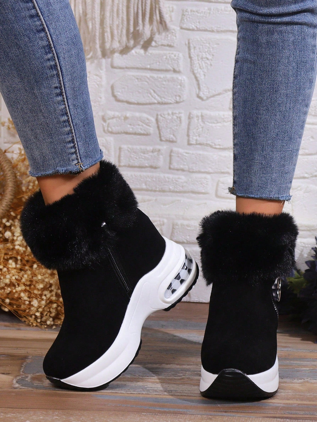 Black platform boots with faux fur detail close up
