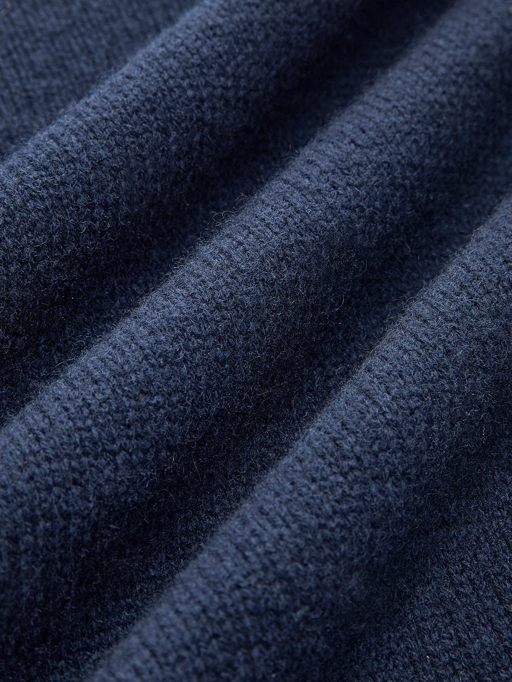 Model wearing layered knit jumper with collar