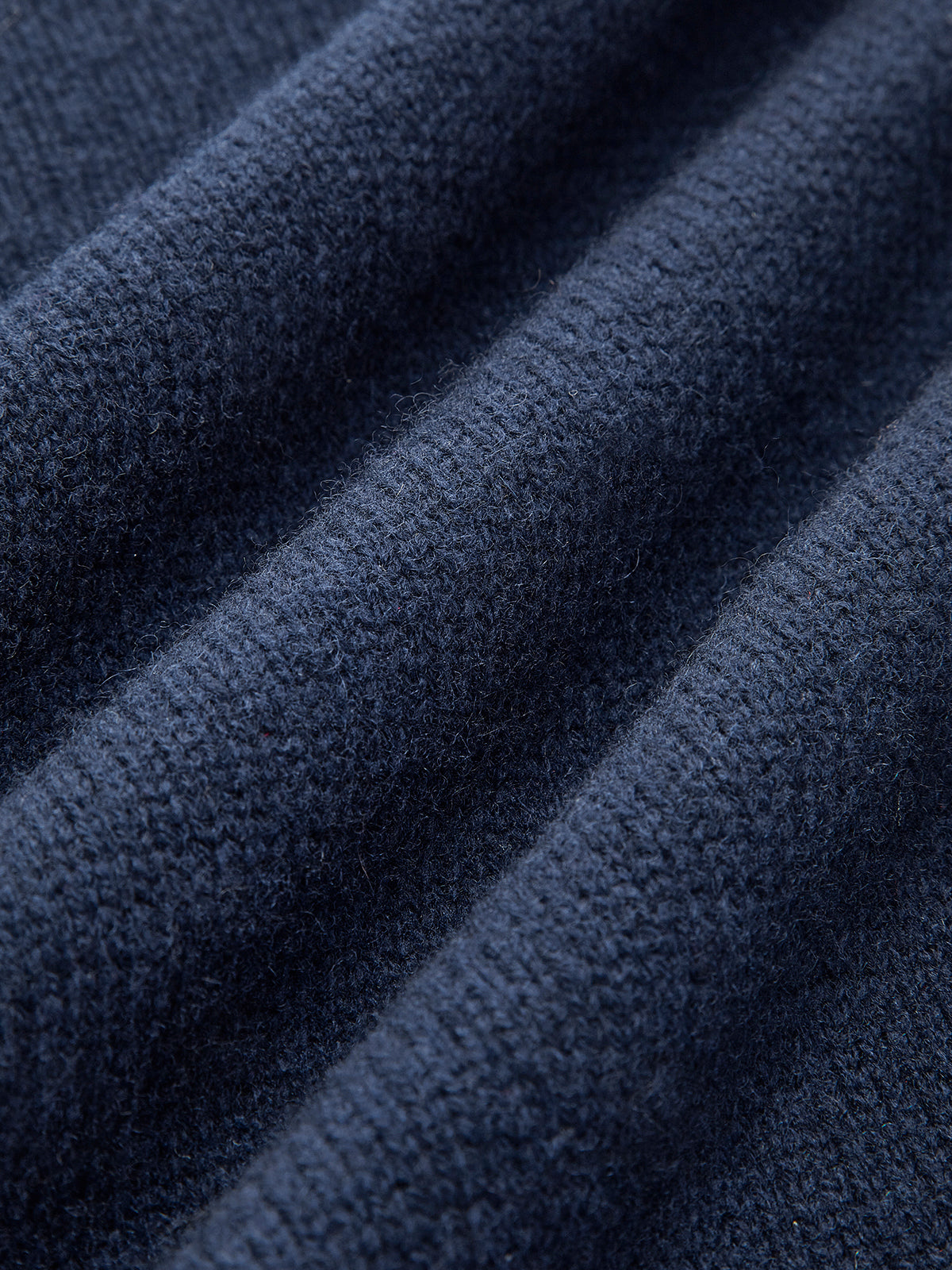 Model wearing layered knit jumper with collar