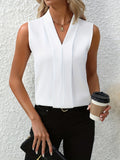 White pleated V-neck sleeveless blouse front view