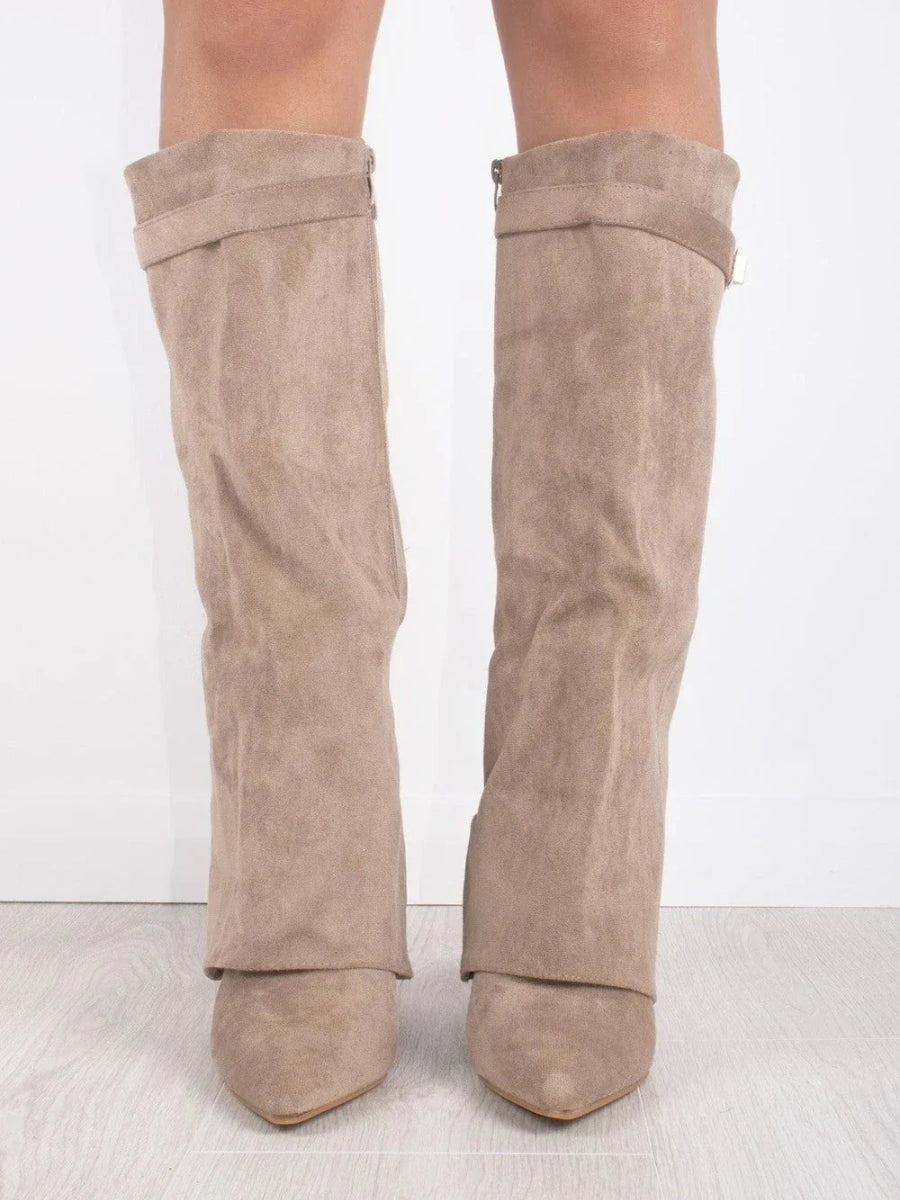 Pair of suede boots on display