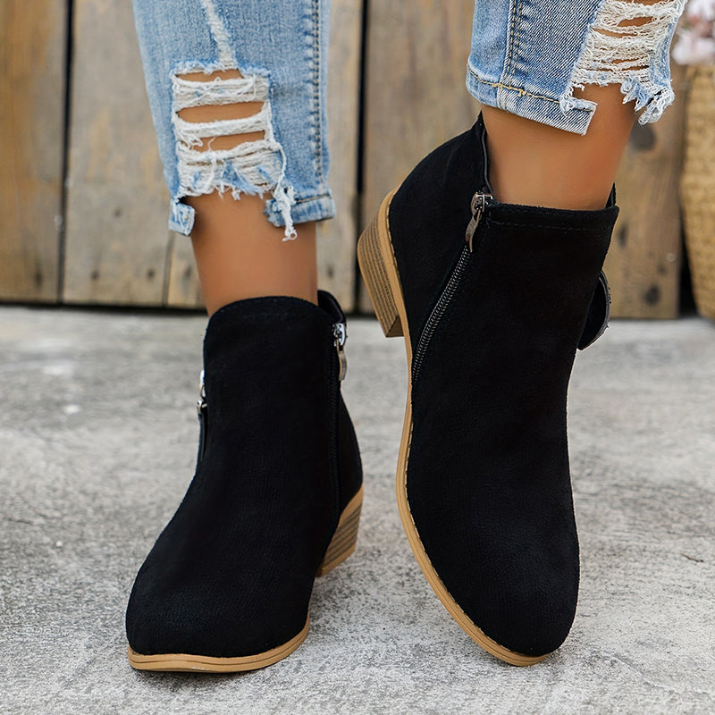 Suede ankle boots worn on foot