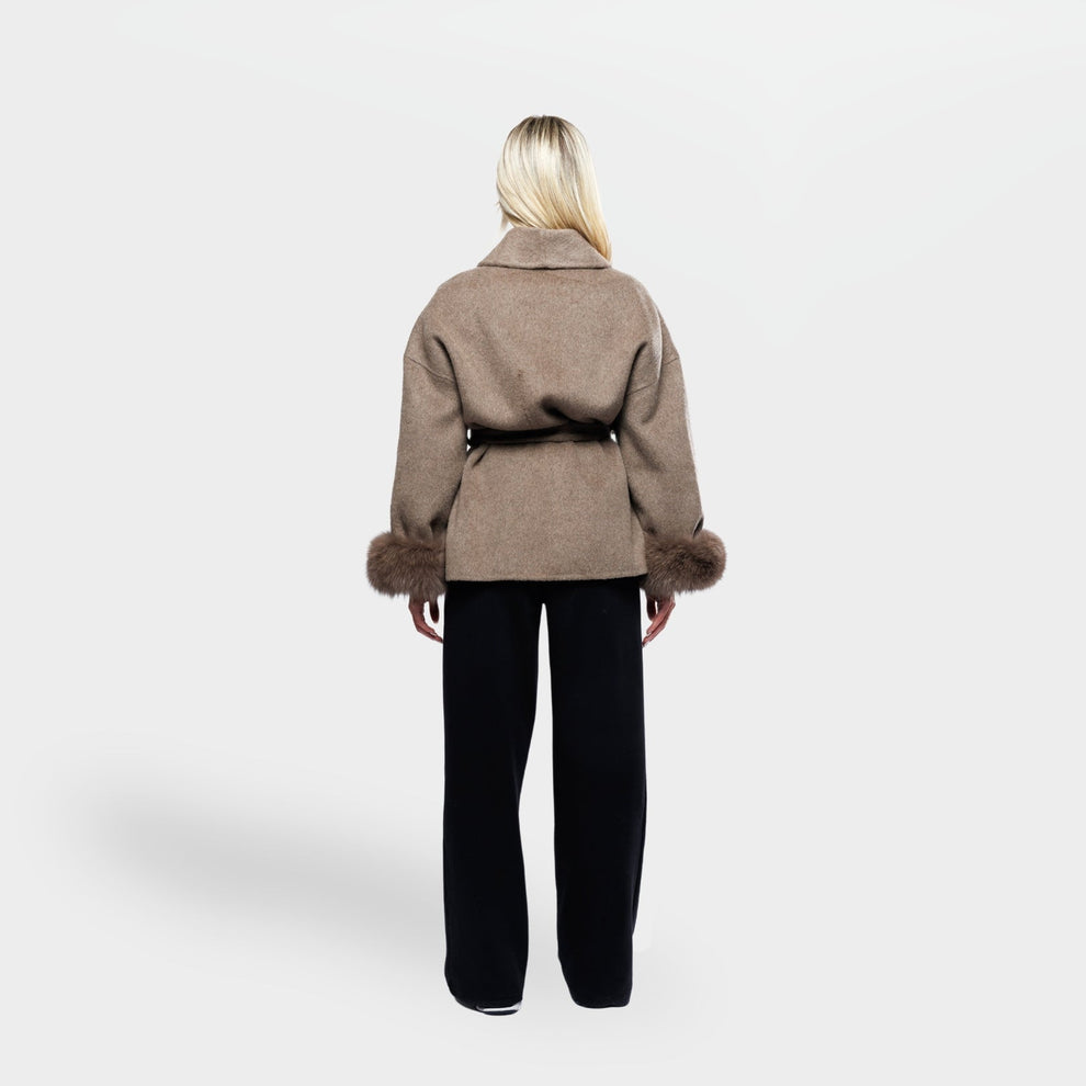 Woman wearing brown winter coat with tie belt