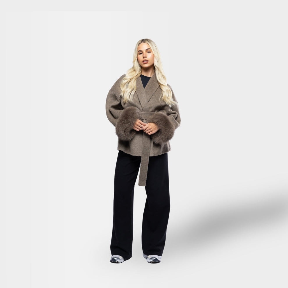 Winter coat styled with dress and boots