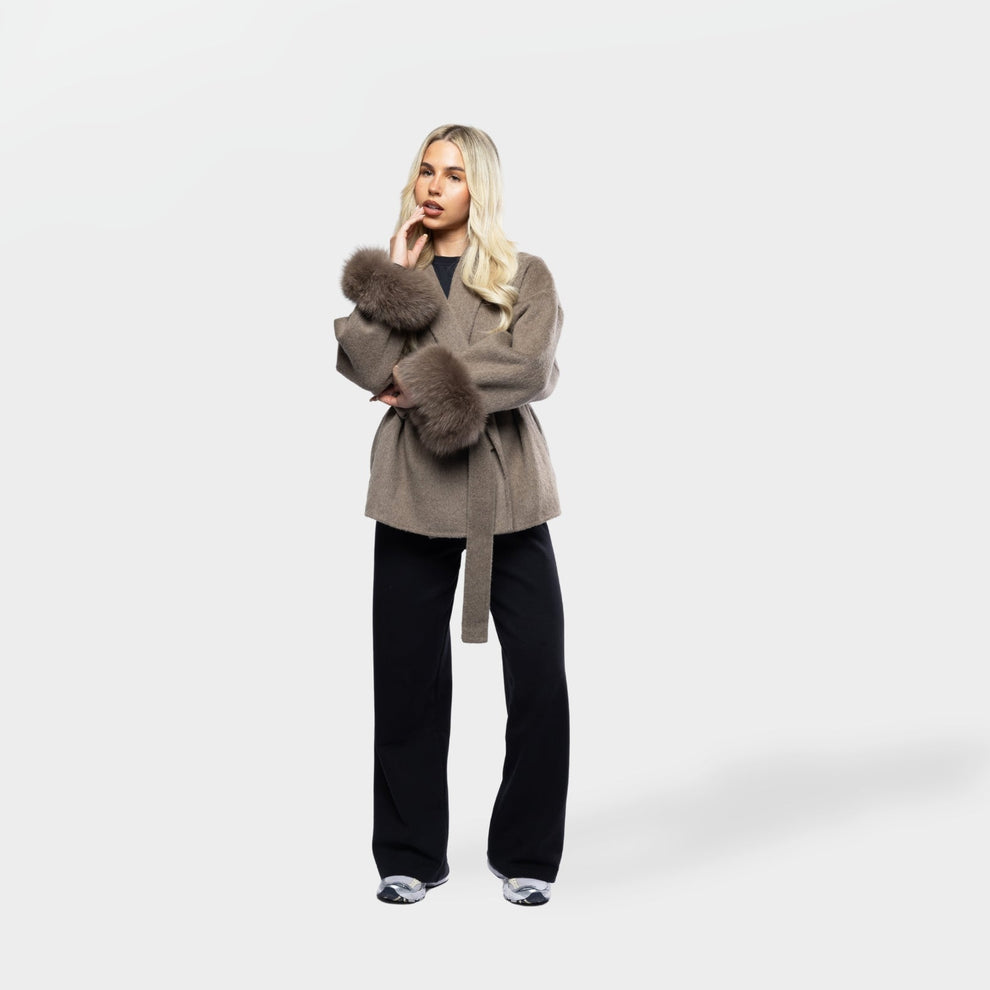 Winter coat styled with jeans and trainers